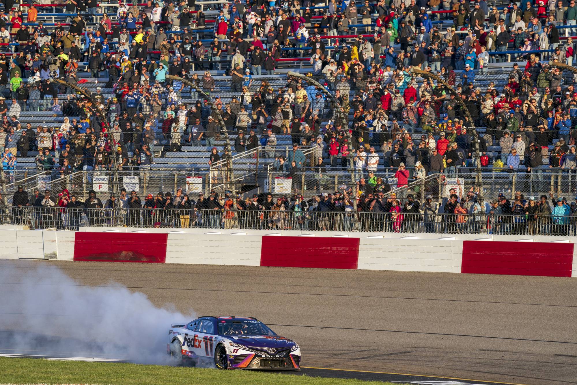 Denny Hamlin does a burnout after winning at Richmond International Raceway